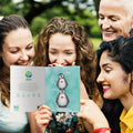 Load image into Gallery viewer, Lifestyle image(s) featuring Tree-Free’s Penguin Pile Thinking Of You Card card
