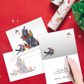 Load image into Gallery viewer, The inside of Tree-Free’s Cat Bird Christmas card, with the cover and envelope in the background.

