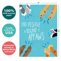 Load image into Gallery viewer, The cover of Tree-Free’s Round of Appaws card with lines demonstrating its 5x7 dimensions, along with the following text: “100% PCW recycled paper, proudly made in the USA, sustainably printed on extra-thick card stock”

