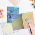 Load image into Gallery viewer, The inside of Tree-Free’s Strength For Today Support Card card, with the cover and envelope in the background.
