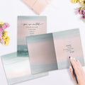 Load image into Gallery viewer, The inside of Tree-Free’s Invited to Be Held card, with the cover and envelope in the background.
