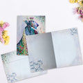 Load image into Gallery viewer, The inside of Tree-Free’s Bear and Peacock card, with the cover and envelope in the background.
