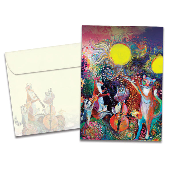The cover of Tree-Free's Animal Serenade Birthday card, along with its matching envelope. The card cover features a group of forest animals playing musical instruments in front of a painted sunset background.
