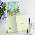 Load image into Gallery viewer, The inside of Tree-Free’s Bunny Family Wishes card, with the cover and envelope in the background.

