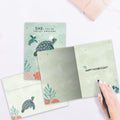 Load image into Gallery viewer, The inside of Tree-Free’s Shellebrating You card, with the cover and envelope in the background.

