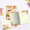 Load image into Gallery viewer, The inside of Tree-Free’s Mushroom Forest card, with the cover and envelope in the background.
