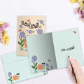 Load image into Gallery viewer, The inside of Tree-Free’s Slow Down card, with the cover and envelope in the background.
