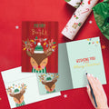 Load image into Gallery viewer, The inside of Tree-Free’s Merry Bright Reindeer card, with the cover and envelope in the background.
