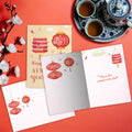 Load image into Gallery viewer, The inside of Tree-Free’s Happiness Lanterns card, with the cover and envelope in the background.
