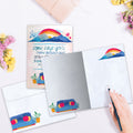 Load image into Gallery viewer, The inside of Tree-Free’s Couch Mountains card, with the cover and envelope in the background.
