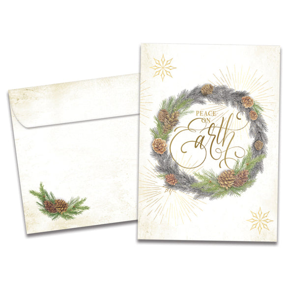 The cover of Tree-Free's Winter Pine Wreath card, along with its matching envelope.
