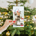 Load image into Gallery viewer, Lifestyle image(s) featuring Tree-Free’s Piled Wild Watercolor card
