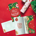 Load image into Gallery viewer, The inside of Tree-Free’s Navidad Ornament card, with the cover and envelope in the background.
